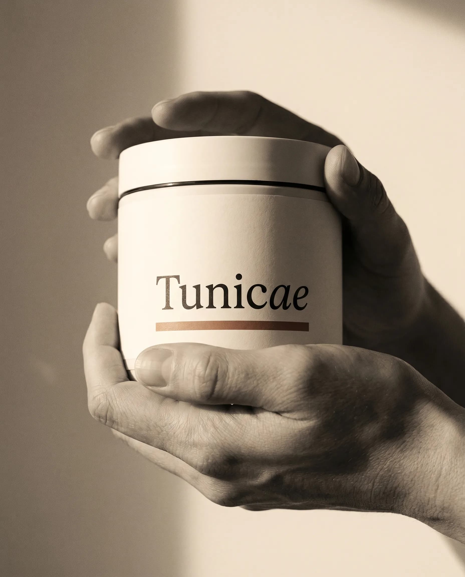 Hands cradling a TUNICAE jar — quiet conviction